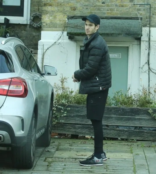 Andrew Garfield wearing his black jacket while entering his car